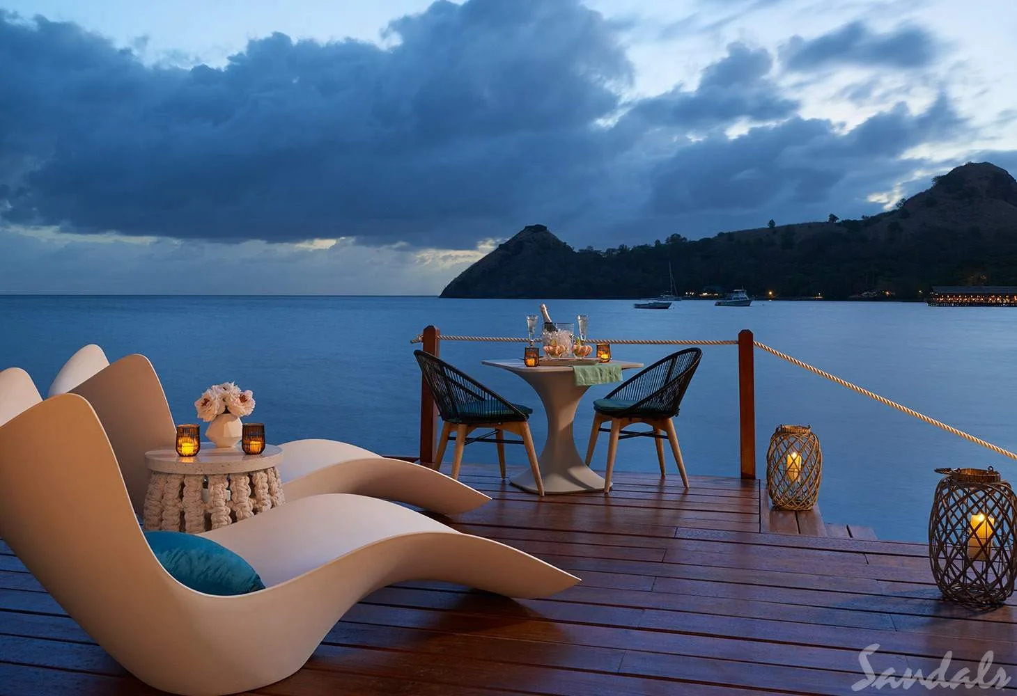 chairs on patio in front of ocean