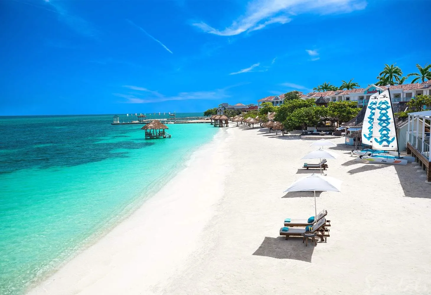 lounge chairs on white sand beach