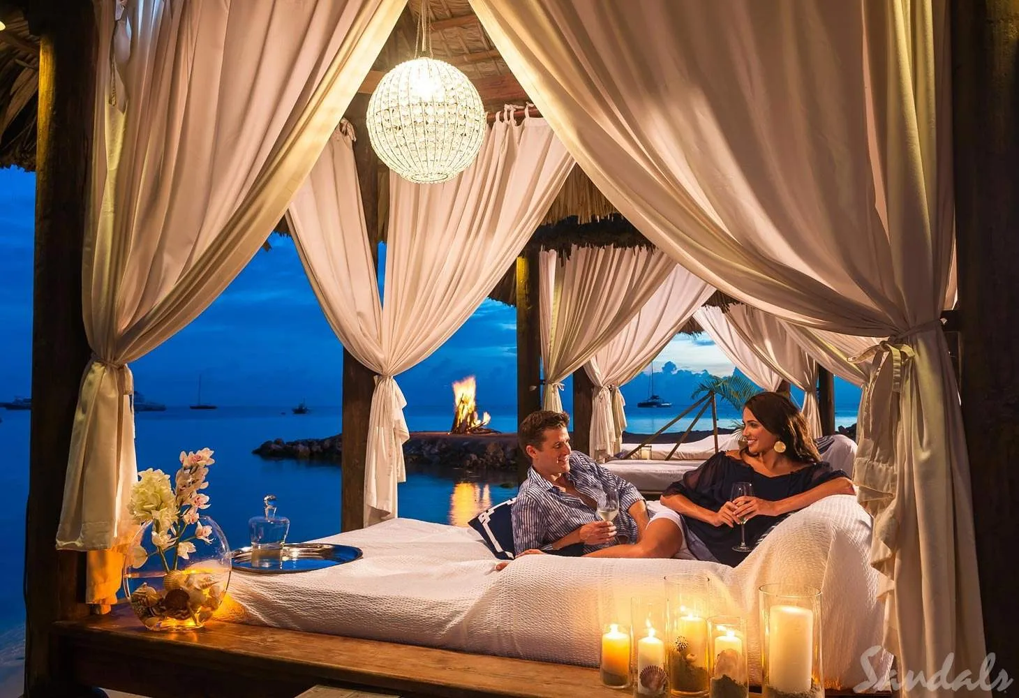 man and woman under cabana at night