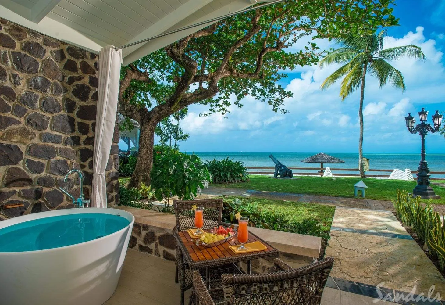 resort room with tub in front of beach