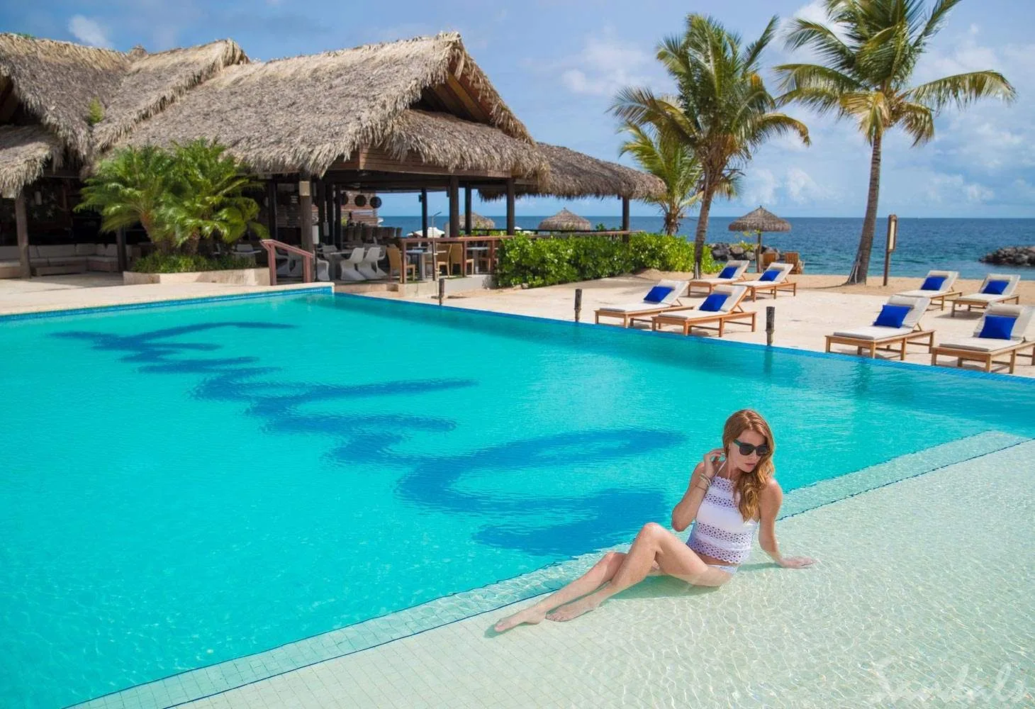 woman sitting by square pool