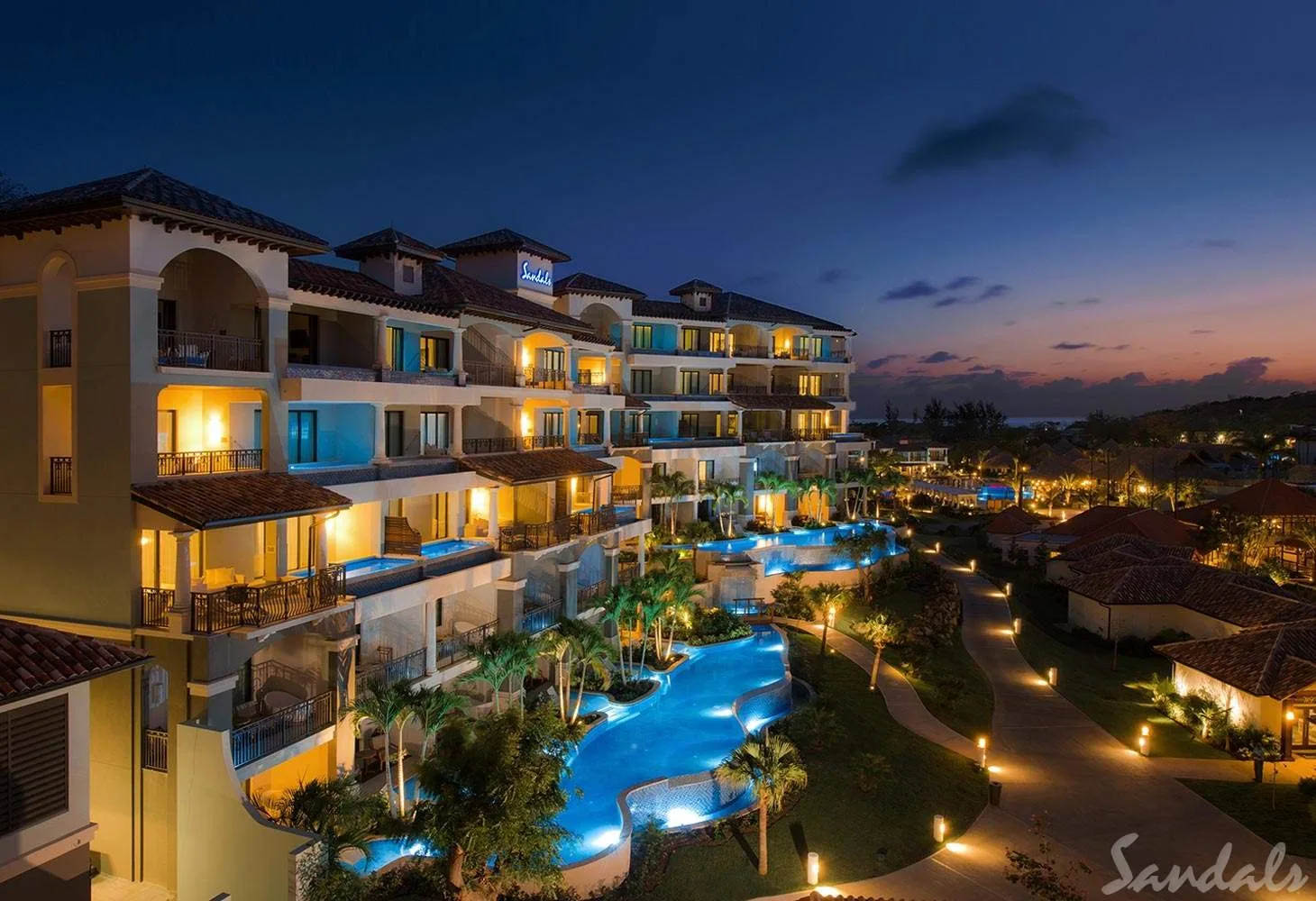 resort with lighted pool at night