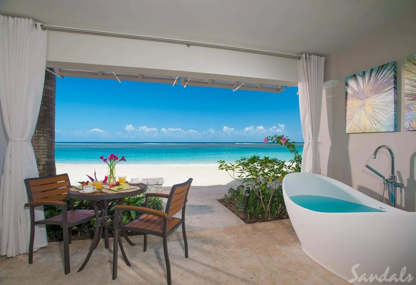 resort room with large opening to beach