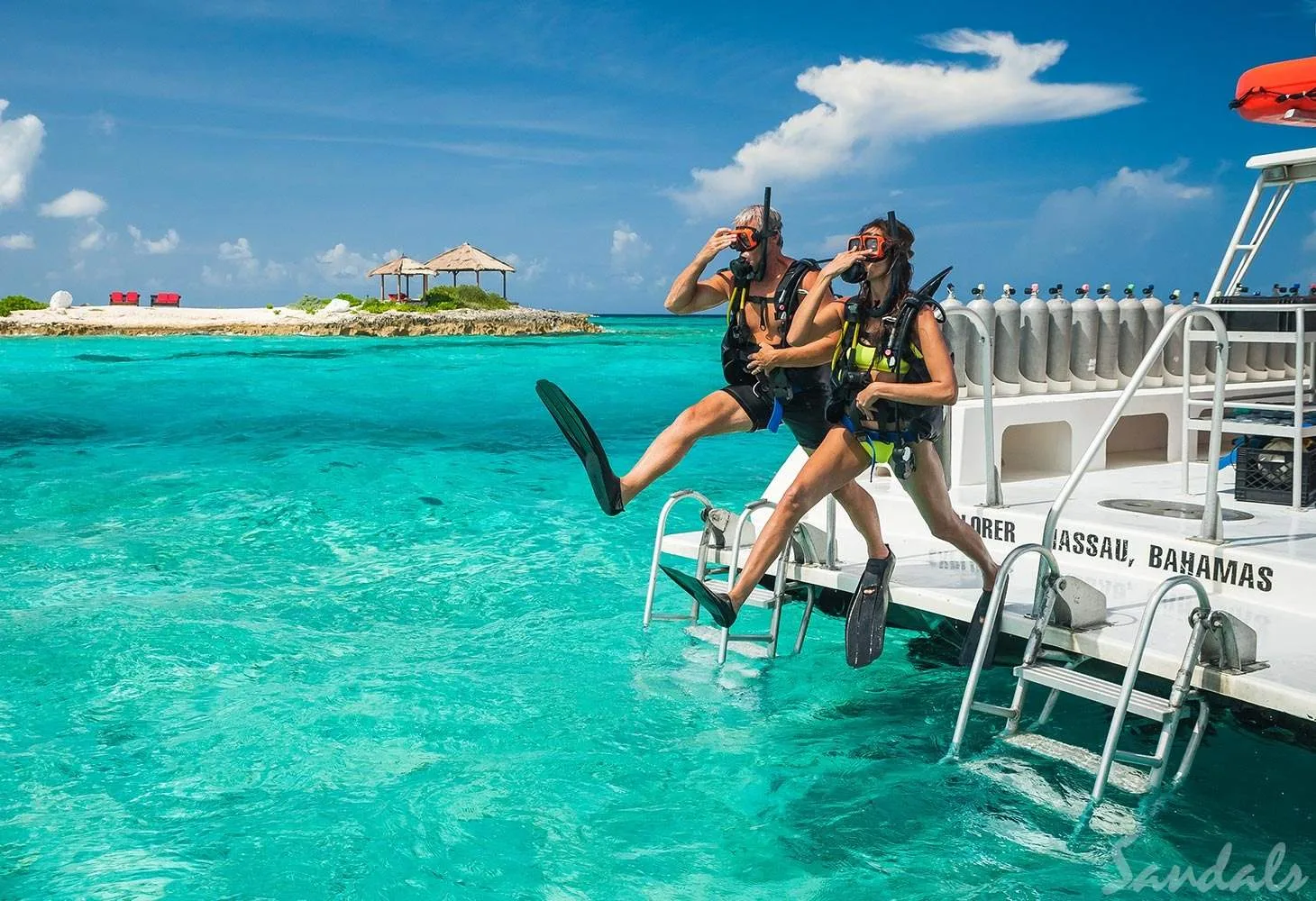 man and woman jumping off boat