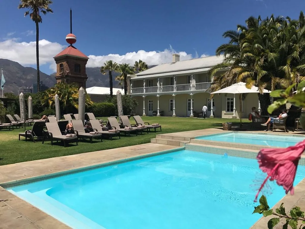 six lounge chairs next to square swimming pool