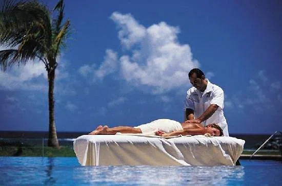 woman getting massage outdoors at a pool
