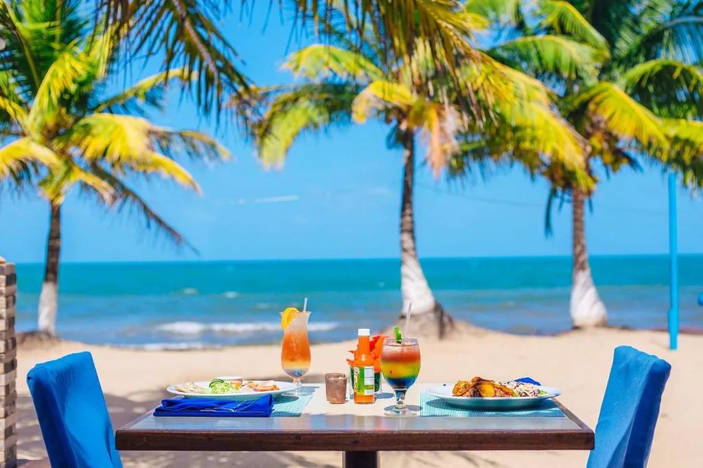 table with food on beach with palm trees