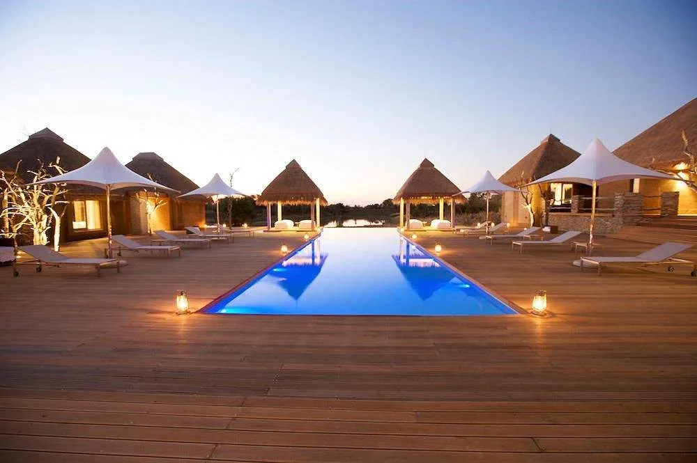 square resort pool surrounded by triangle huts