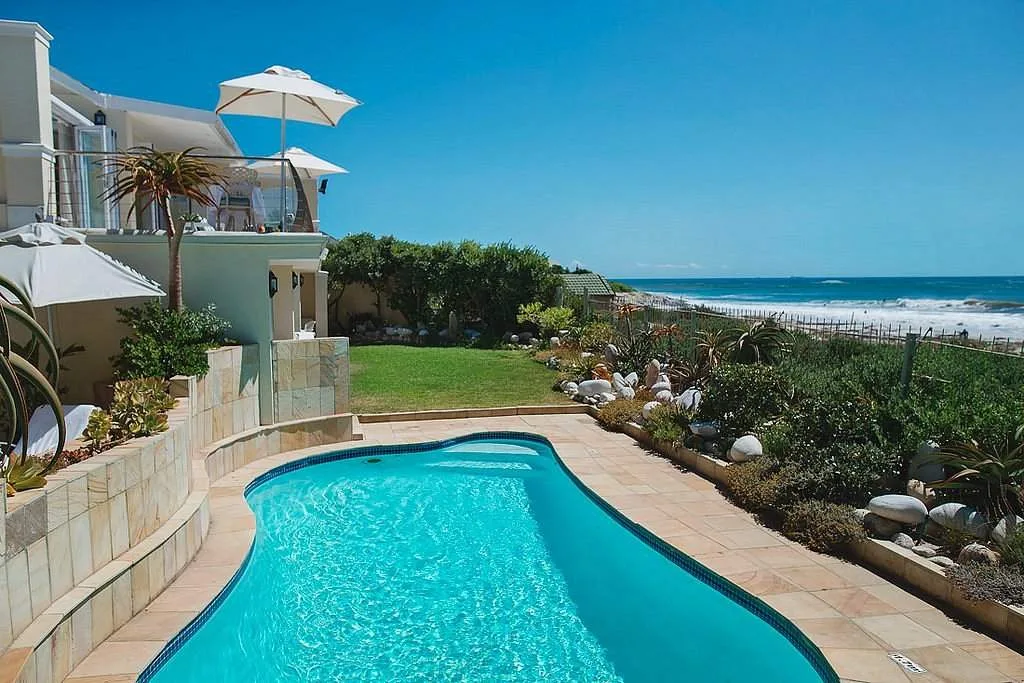 swimming pool with ocean in background