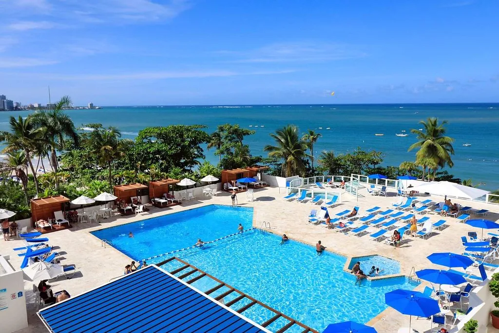 rectangle swimming pool in front of ocean
