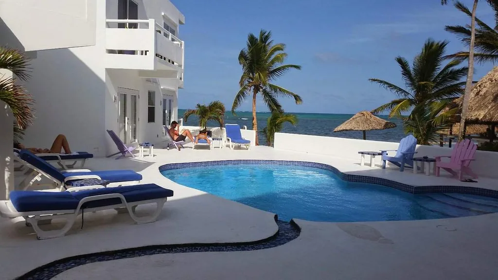 oval shaped resort pool with palm tree