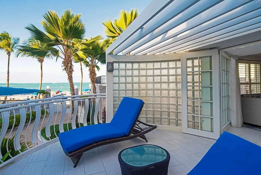 blue lounge chair on resort deck with palm trees