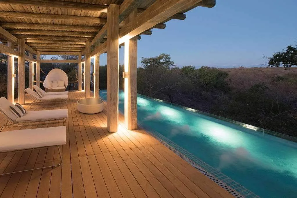 lighted rectangle pool in front of patio