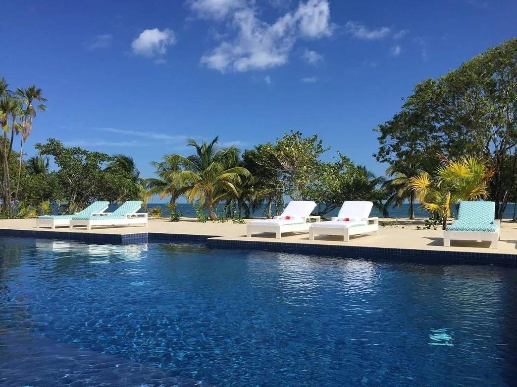 resort pool with white lounge chairs