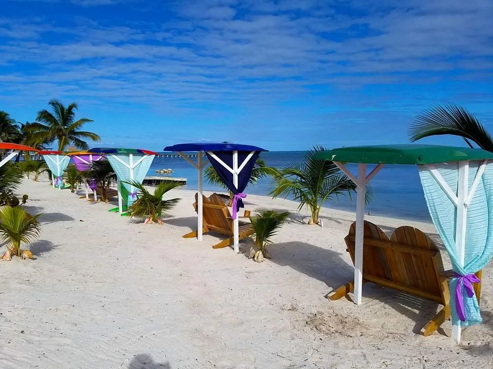 multiple chairs on white sand beach