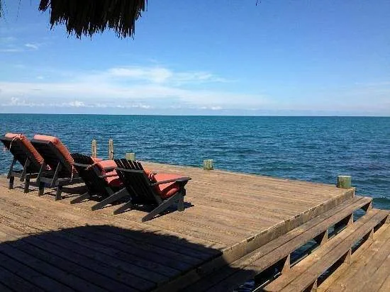 lounge chairs on wooden deck overlooking ocean