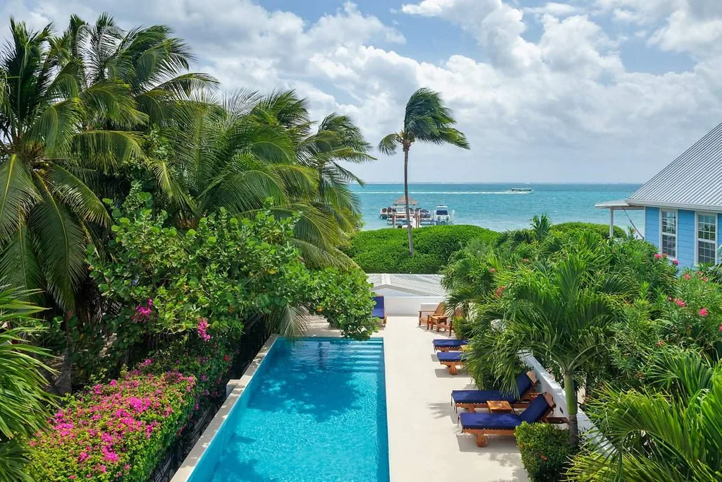 narrow rectangle resort pool surrounded by bushes