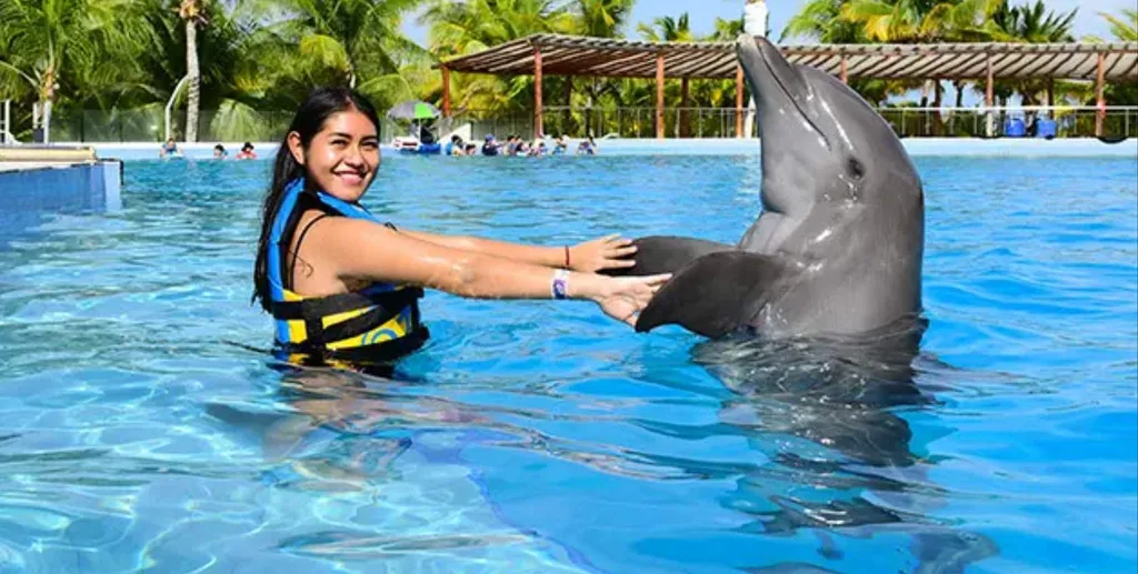 pretty teenage girl holding dolphin fin