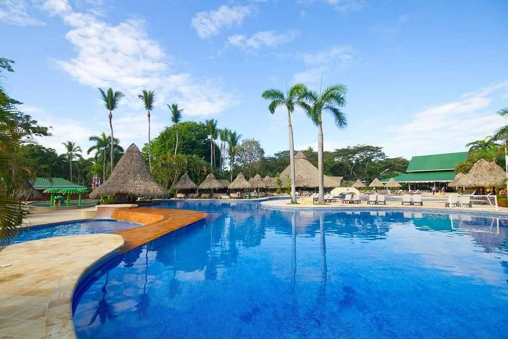 wide resort pool with 5 palm trees