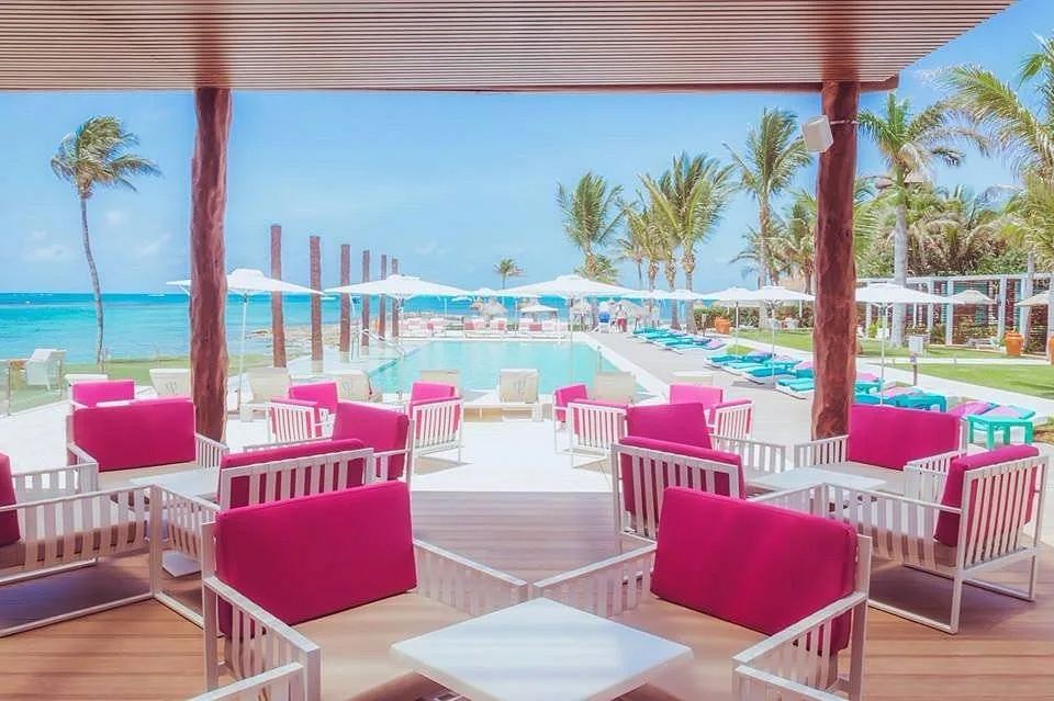 red chairs under canopy next to pool