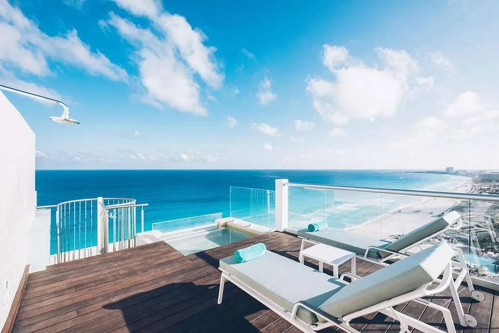 lounge chairs on wooden deck overlooking ocean
