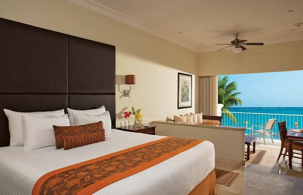 resort room bed with large window facing ocean