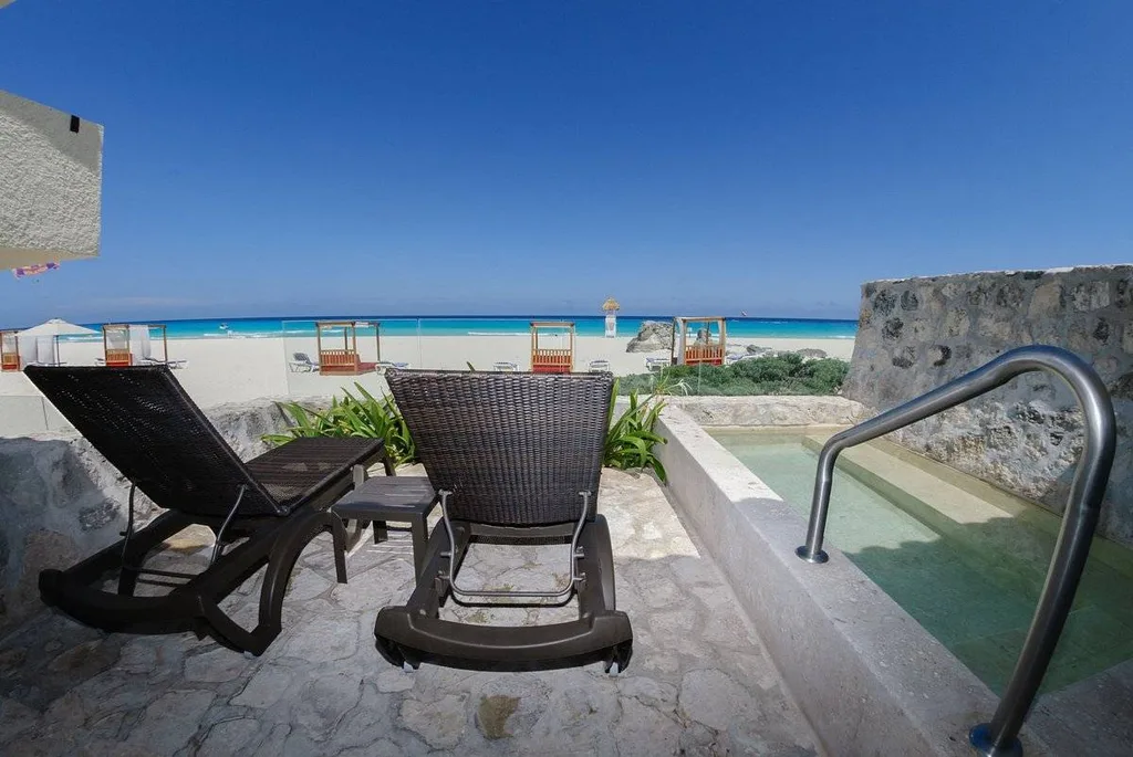 two lounge chairs on patio on private beach