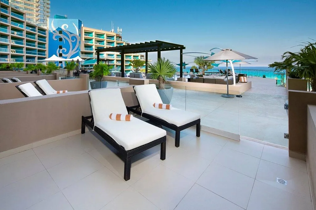 two white lounge chairs at resort pool