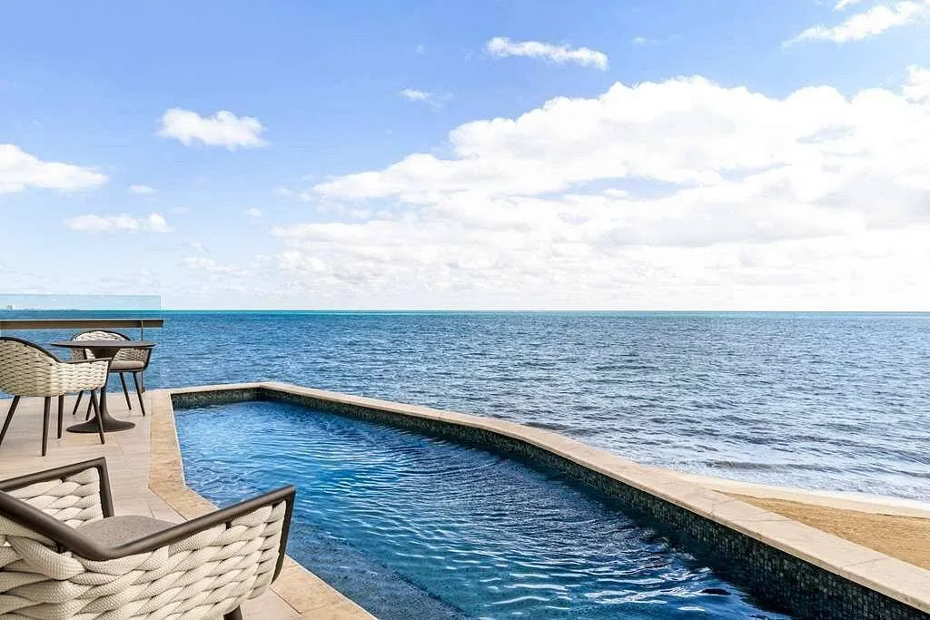 swimming pool surrounded by ocean