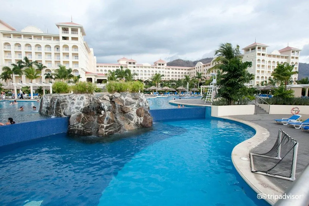 curved resort pool with rock formation