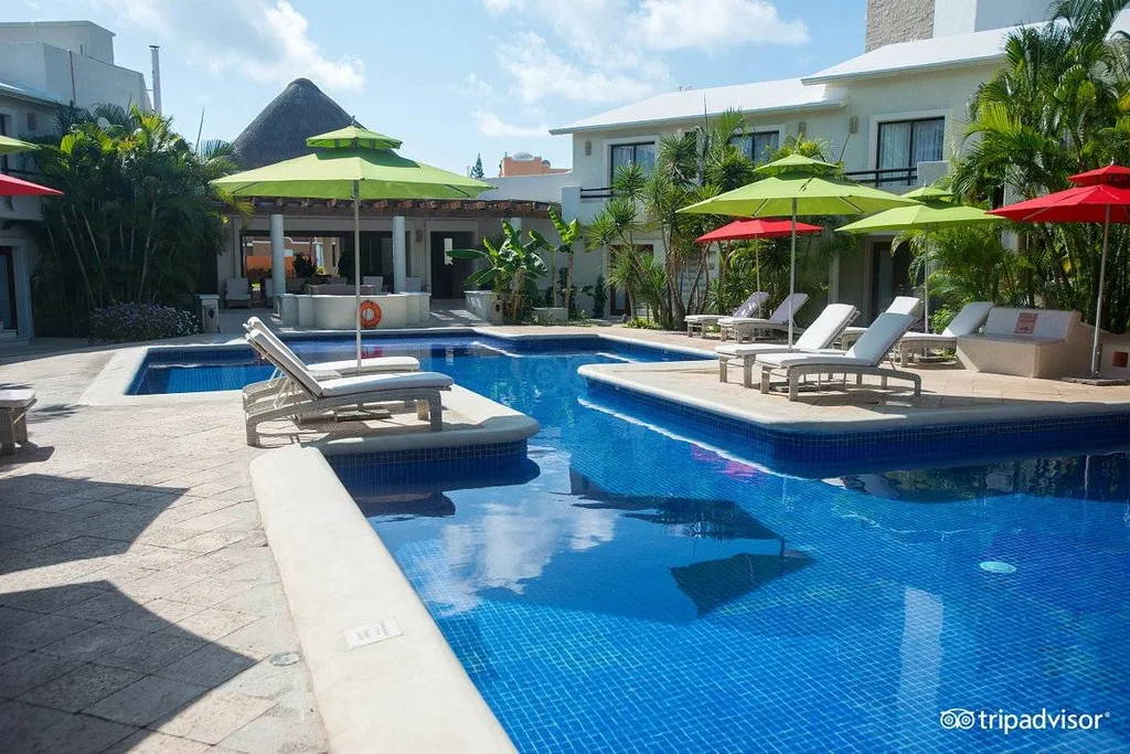 resort pool with green umbrellas