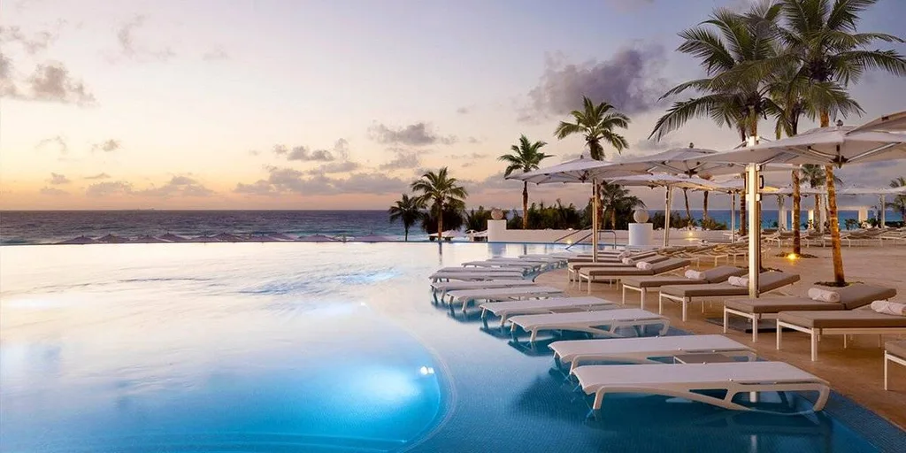 long white lounge chairs in resort pool