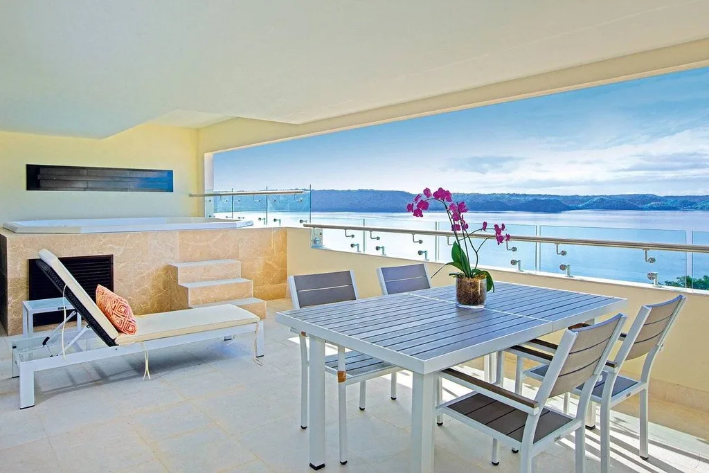 resort room with wide opening looking out to ocean