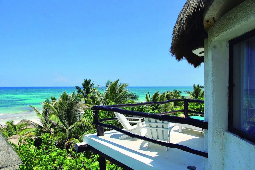 resort balcony overlooking trees to ocean