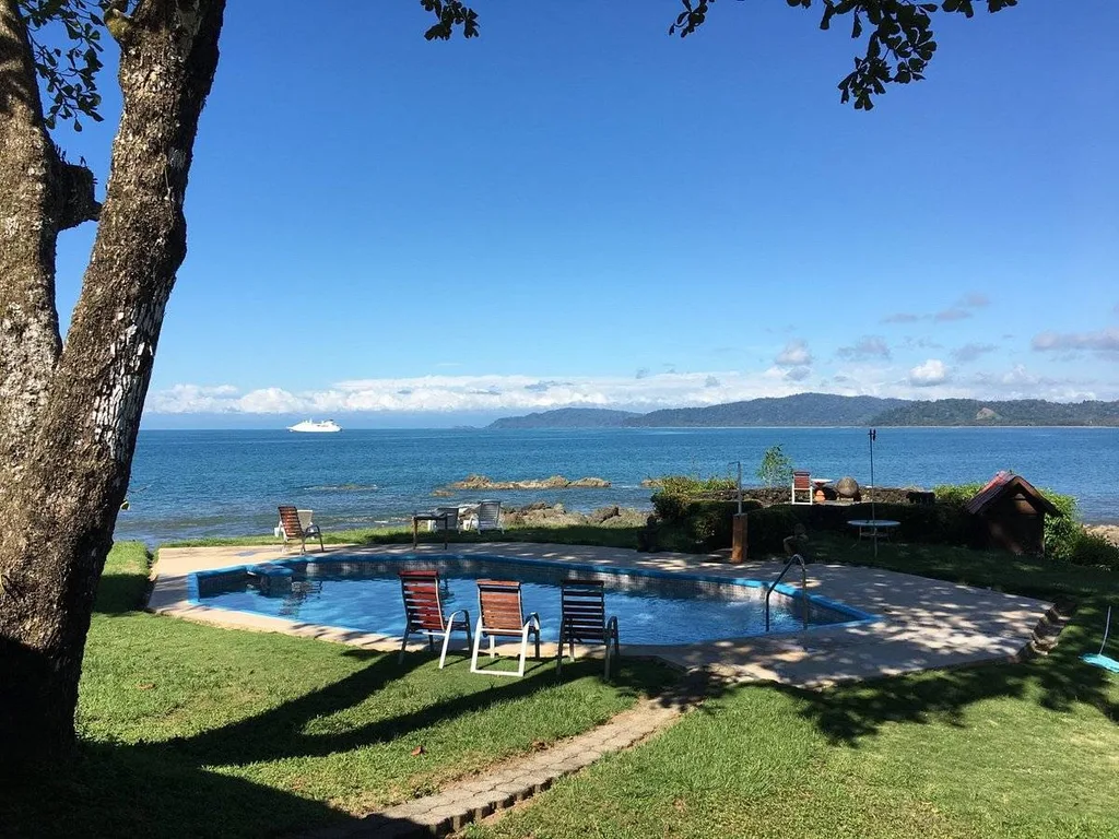 swimming pool with expansive ocean in bacckground