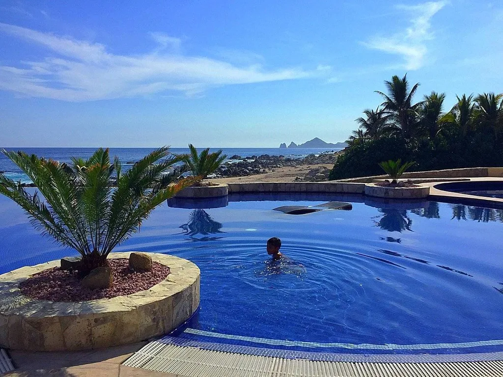 deep blue round infinity pool at ocean