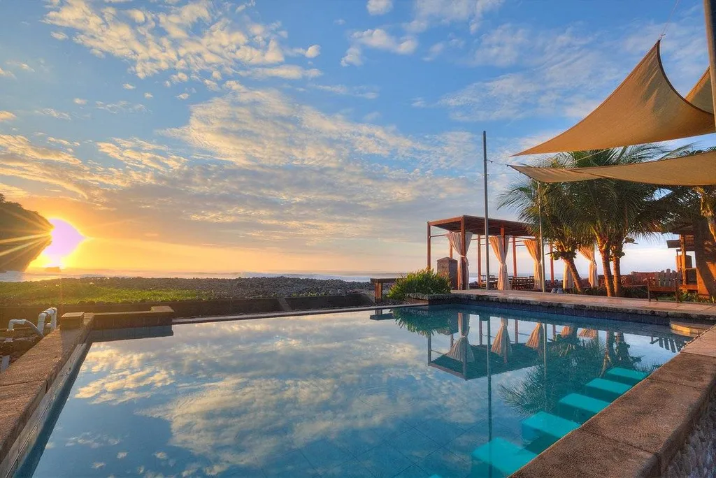 large square infinity pool at sunset