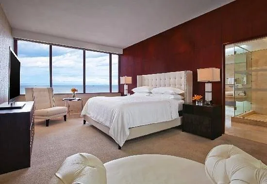 bed in resort room with large windows