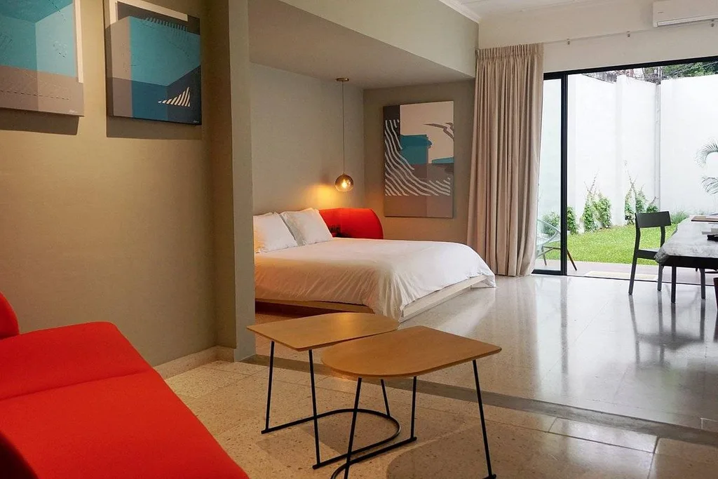 hotel room with bed and red chair