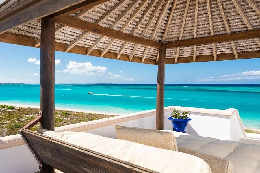 lounge furniture under canopy on beach