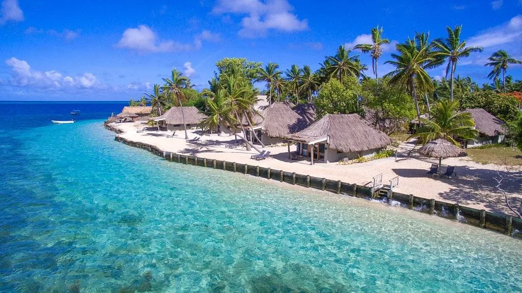 thatched roof buildings along shoreline