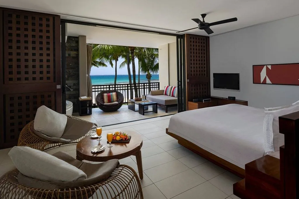 resort room with wide widow looking out to beach