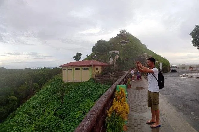 man taking picture from road