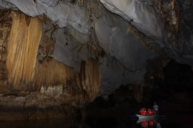 people in boat in a cave