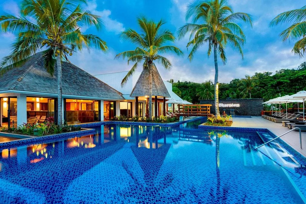 resort pool with 3 palm trees