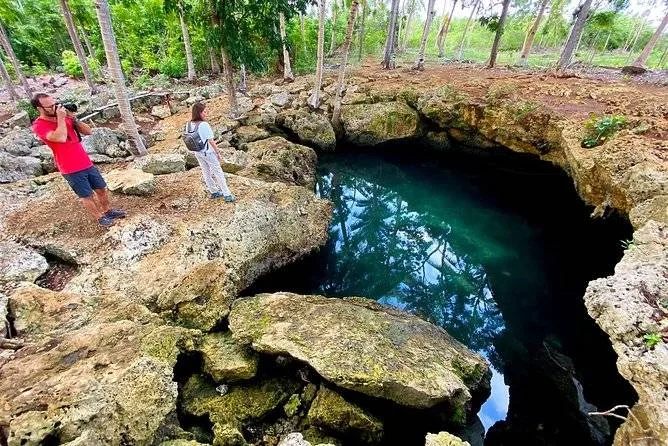 man looking into crater with water