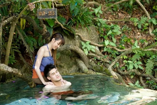 couple relaxing in hot spring in jungle