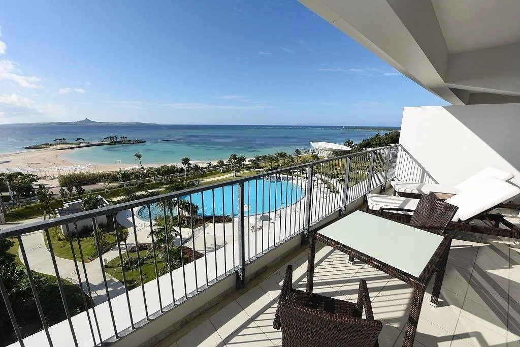 resort balcony overlooking pool and ocean