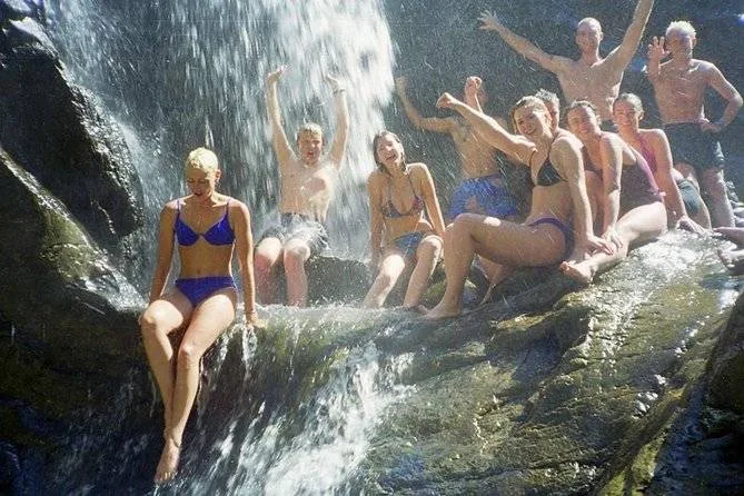group of people posing on rock