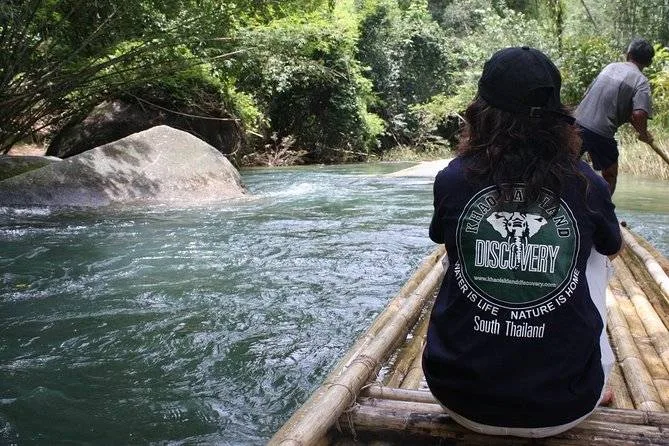 woman floating on bamboo raft